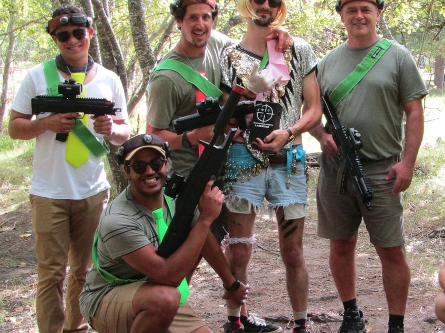 A corporate team in the forest with their laser tag guns