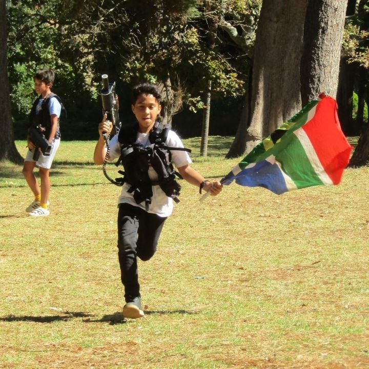 A player running with the South African flag