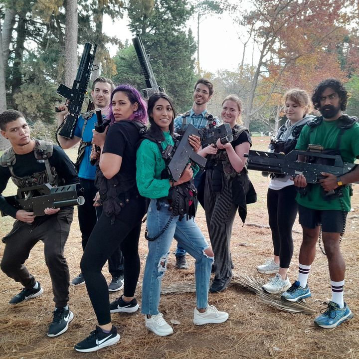 A line of teenage players with laser tag guns