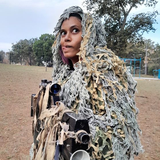 A woman in a ghillie suit