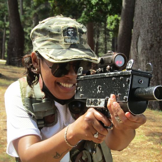 A woman smiles as she aims