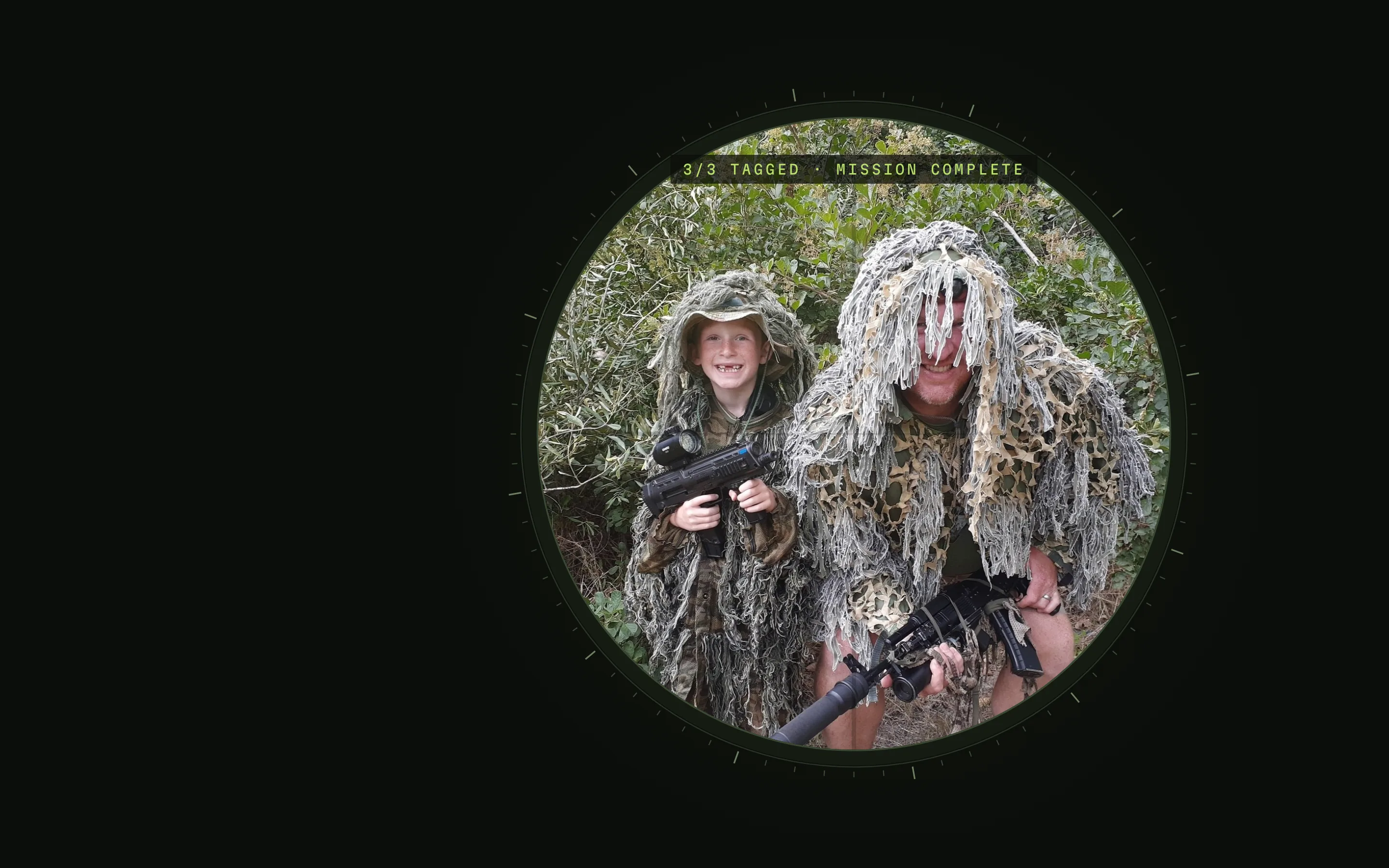 Through the scope: The birthday child and their dad, in ghillie suits.
